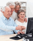 Older adults sitting in front of a computer screen