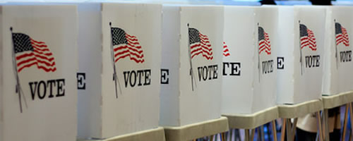 voting booths with American flag and and word vote on them